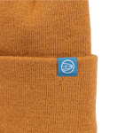 Brown knit beanie with small blue square logo patch at cuff