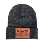 Grey knit beanie hat with fold-up cuff and STLHD leather logo patch
