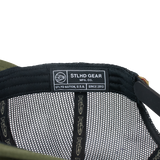 Olive green trucker cap interior with STLHD GEAR label and mesh lining