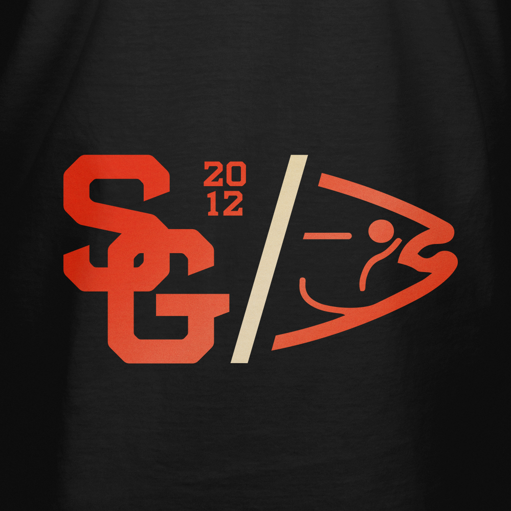 Black varsity T-shirt close-up: orange and cream chest logo graphic.