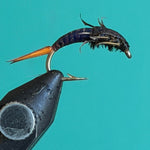 Fishing fly nymph lure: dark black body, orange tail, two metal hooks