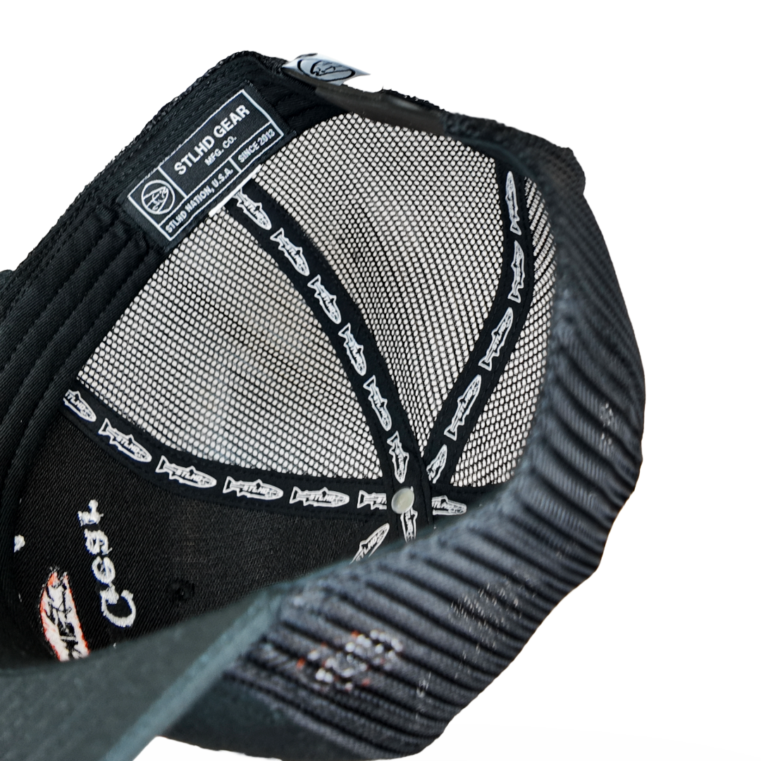 Black trucker cap interior with mesh backing and printed logo band