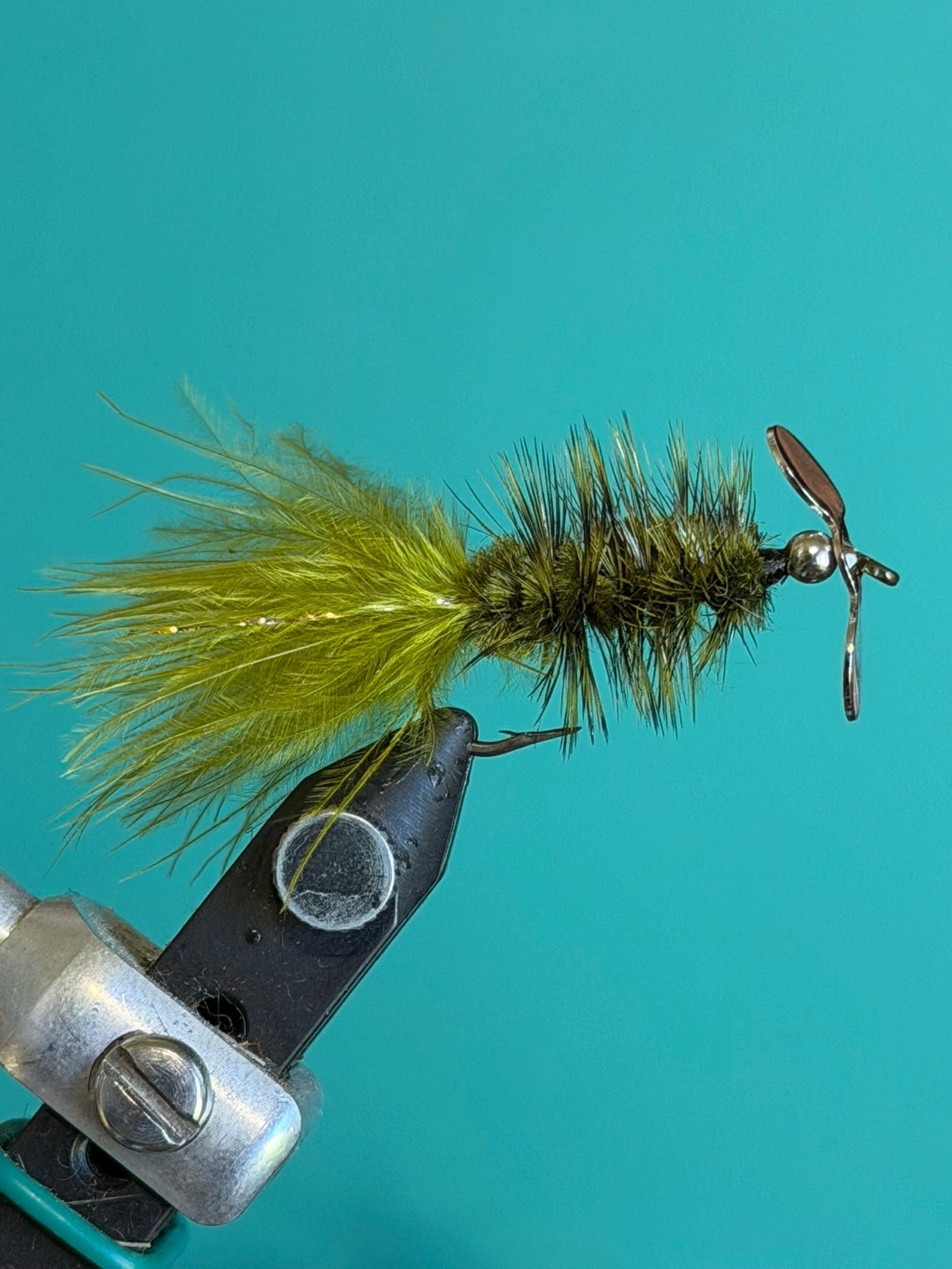 Fishing lure with yellow-green marabou body and metal propeller blade tail