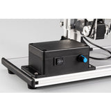 Black control box with on/off switch and blue button on machine base