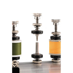 Spool holders with green and orange thread reels on machine