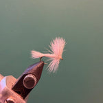 Wulff fly fishing lure with light pink fuzzy fibers and brown hook