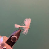 Wulff fly fishing lure with light pink fuzzy fibers and brown hook