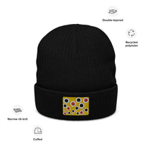 Black ribbed knit beanie with multicolor patch on front and folded cuff.